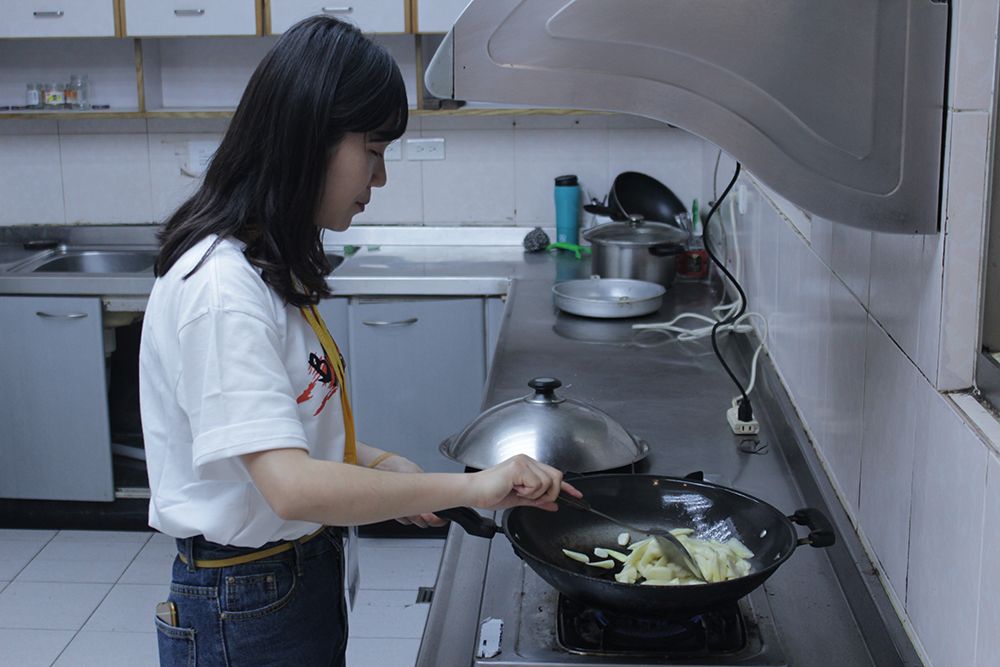 Project team member cooking in a kitchen