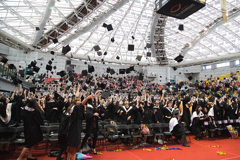 Graduates throwing caps at commencement ceremony