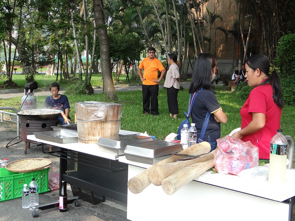 Saisiyat tribe members prepare water-boiled pork (“ayam”) and sticky rice cake (“tinawbon”) for the opening ceremony.