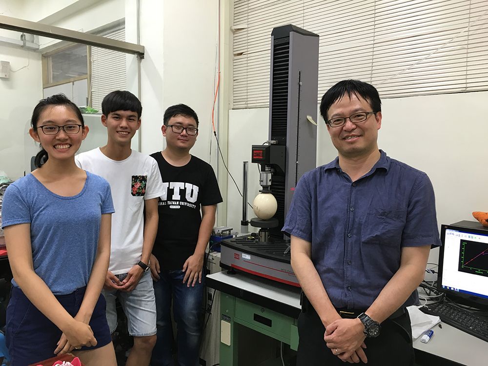 The NTU team stand in front of the compression tester. The sample in the photo is an ostrich egg.