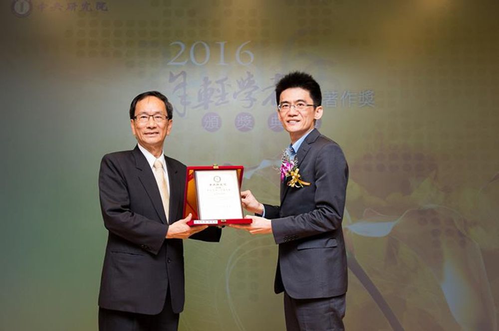 林先和副教授(右)自頒獎者中研院王惠鈞副院長手中接受獎牌。